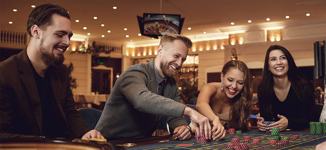 A group of people playing roulette.