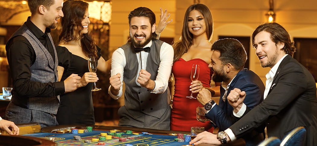 A group of people playing roulette.