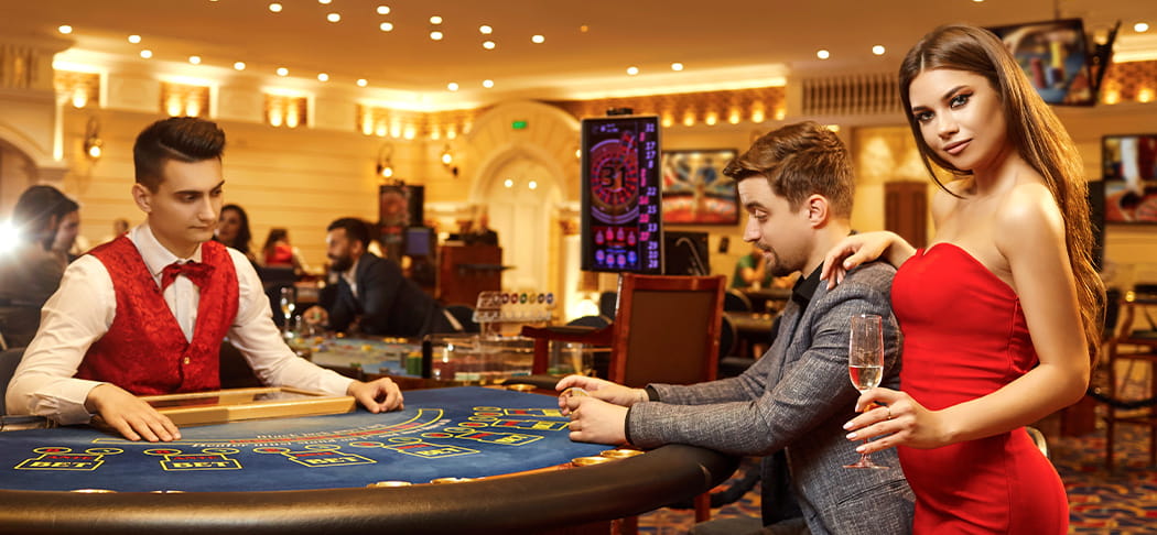 A man and woman play blackjack.