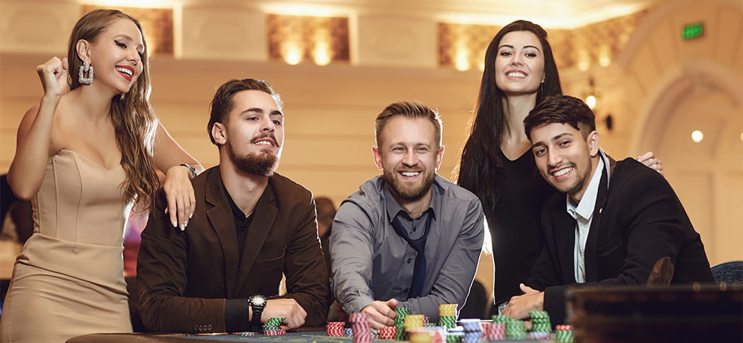 Players around a roulette table.