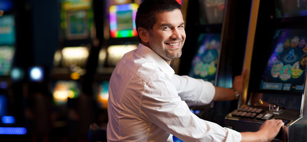 A man plays a slot machine.