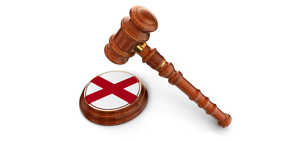 A gavel and the Alabama flag.