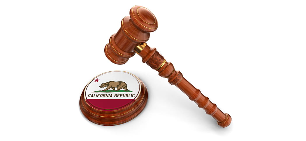 A gavel and the flag of California.
