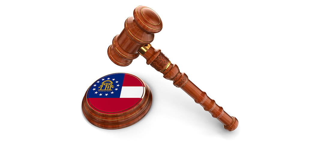 A gavel and the Georgia flag.