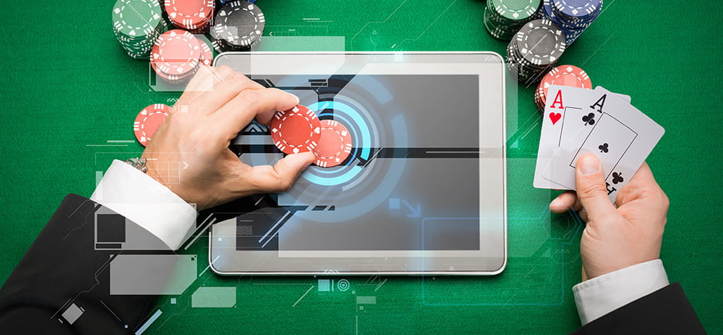 A man placing a blackjack bet on a tablet.