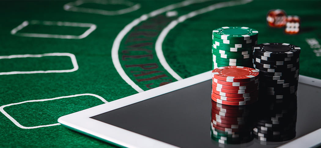 Poker chips on top of a tablet.