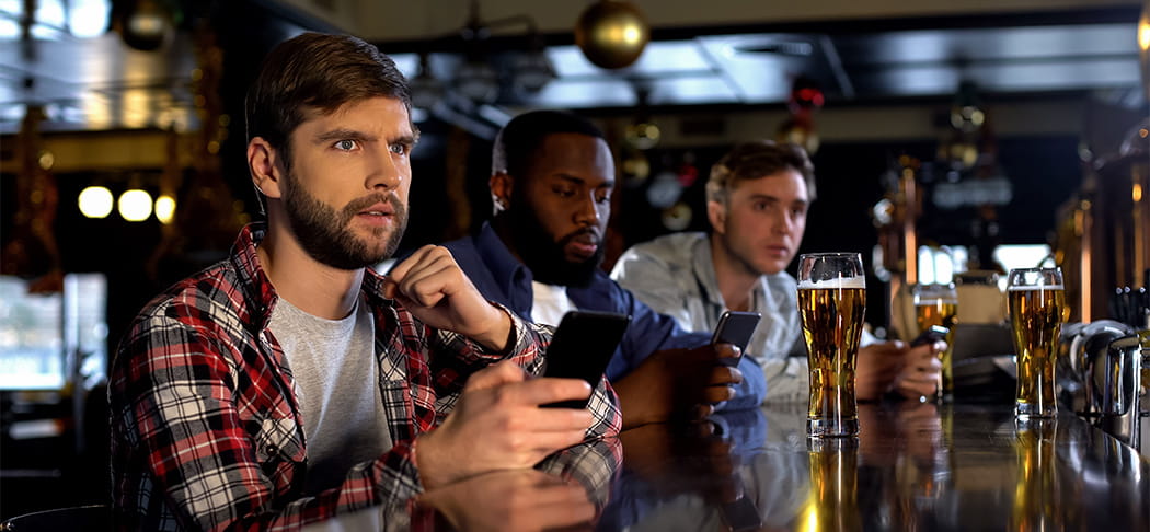 A group of guys watching sports.