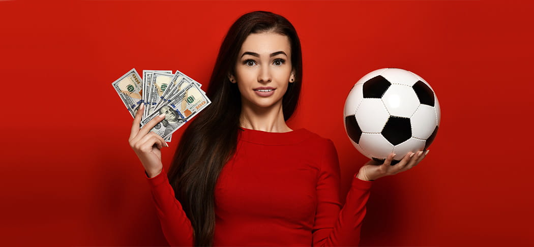 A woman holding cash and a soccer ball.
