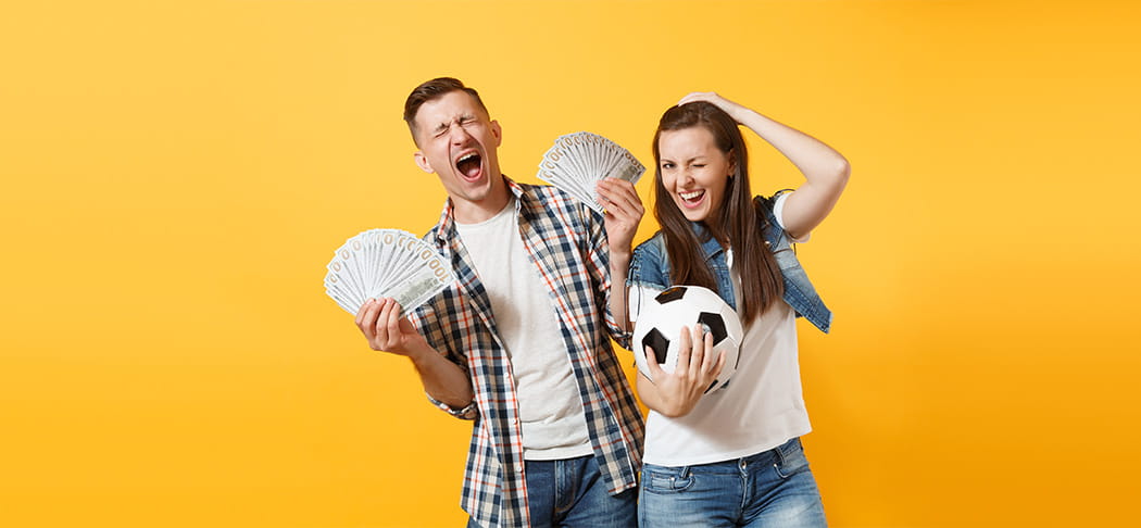 A man and woman celebrate after winning a sports bet.